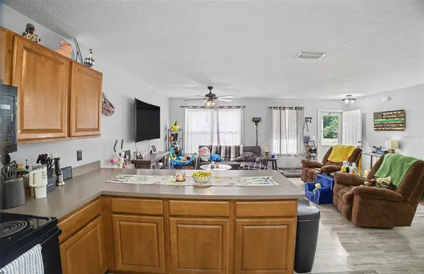 a kitchen with sink and living room