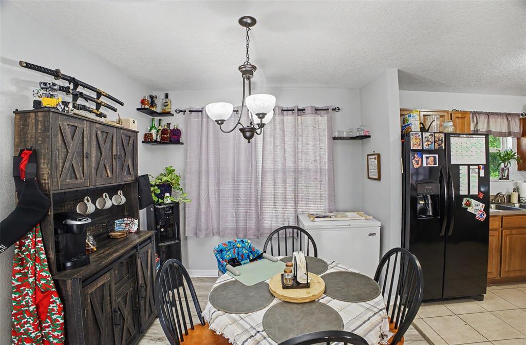 1886 Laurel Avenue Bunnell, FL 32110 - Photo 15 of 31 a dining room with furniture a chandelier and wooden floor