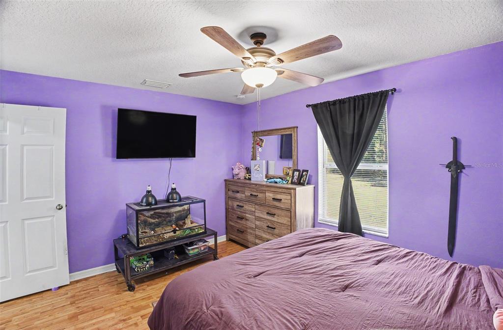 1886 Laurel Avenue Bunnell, FL 32110 - Photo 19 of 31 a bedroom with a bed and a flat screen tv