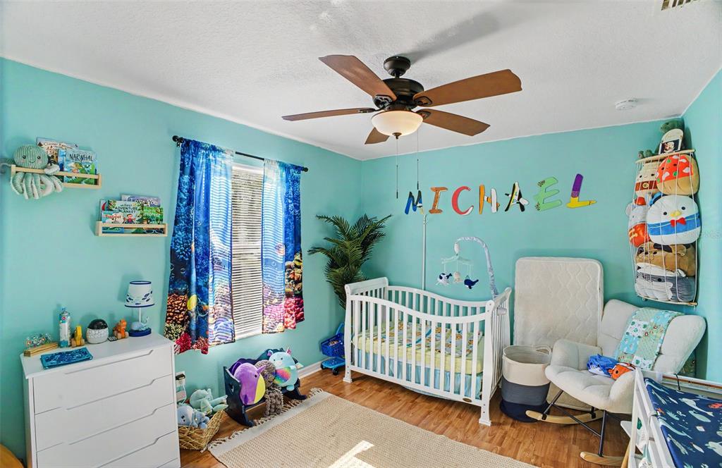 1886 Laurel Avenue Bunnell, FL 32110 - Photo 20 of 31 a bedroom with baby crib and a window