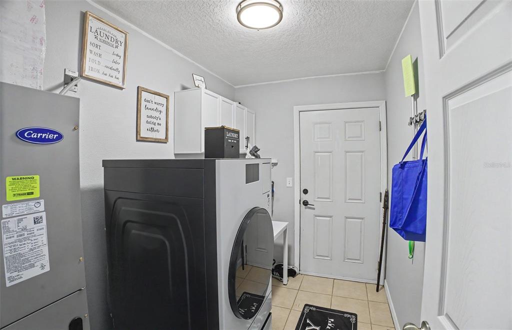 1886 Laurel Avenue Bunnell, FL 32110 - Photo 26 of 31 a view of walk in closet with clothes and shoes