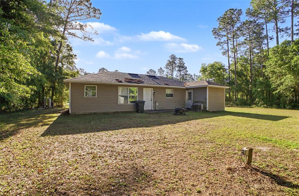 1886 Laurel Avenue Bunnell, FL 32110 - Photo 27 of 31 a front view of a house with a yard and trees