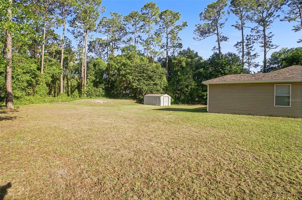 1886 Laurel Avenue Bunnell, FL 32110 - Photo 29 of 31 a house with trees in front of it