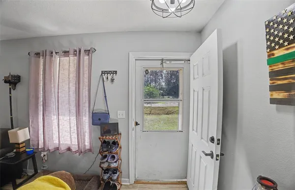 a view of a livingroom with furniture and a window