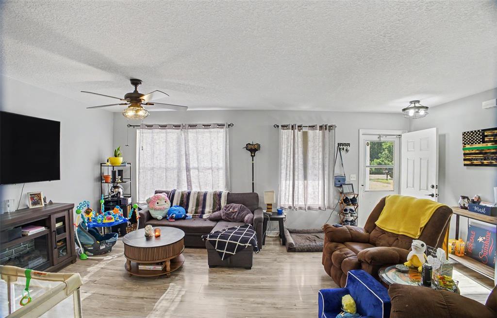 1886 Laurel Avenue Bunnell, FL 32110 - Photo 7 of 31 a living room with furniture and a flat screen tv