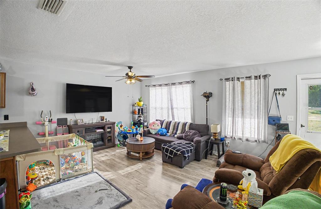 1886 Laurel Avenue Bunnell, FL 32110 - Photo 8 of 31 a living room with furniture and a flat screen tv