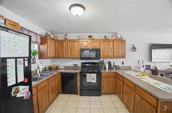 a kitchen with stainless steel appliances granite countertop a stove top oven a sink dishwasher and cabinets
