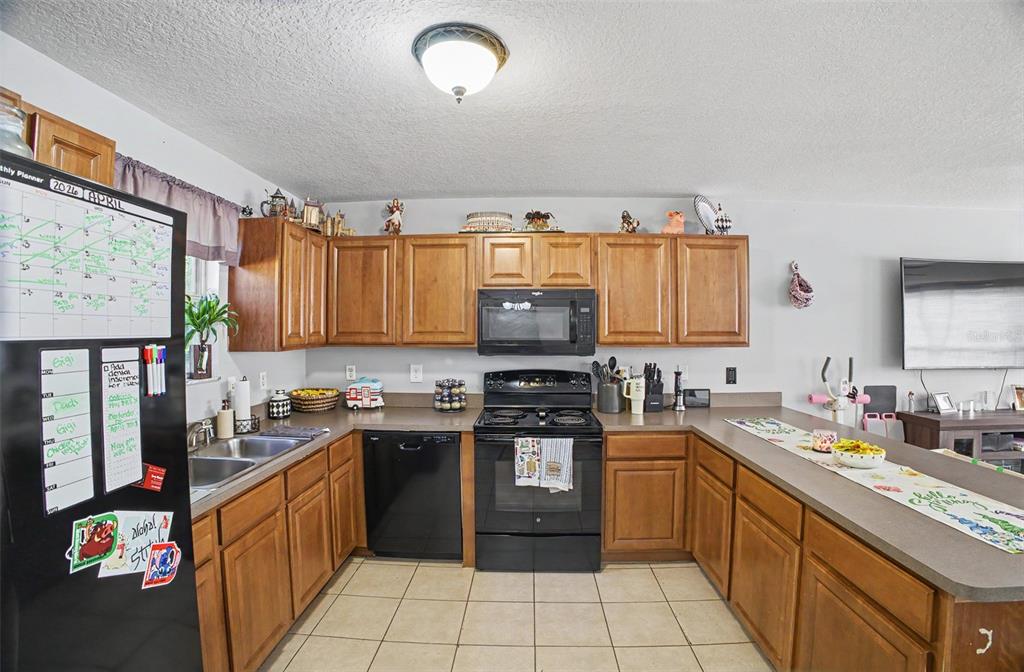 1886 Laurel Avenue Bunnell, FL 32110 - Photo 10 of 31 a kitchen with stainless steel appliances granite countertop a stove top oven a sink dishwasher and cabinets