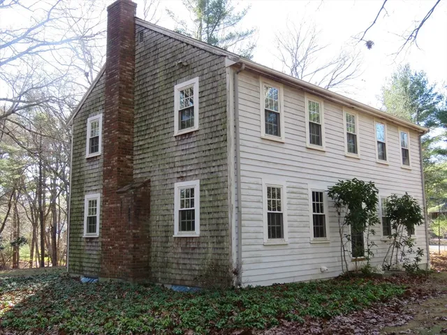 a view of a house with a yard and tree
