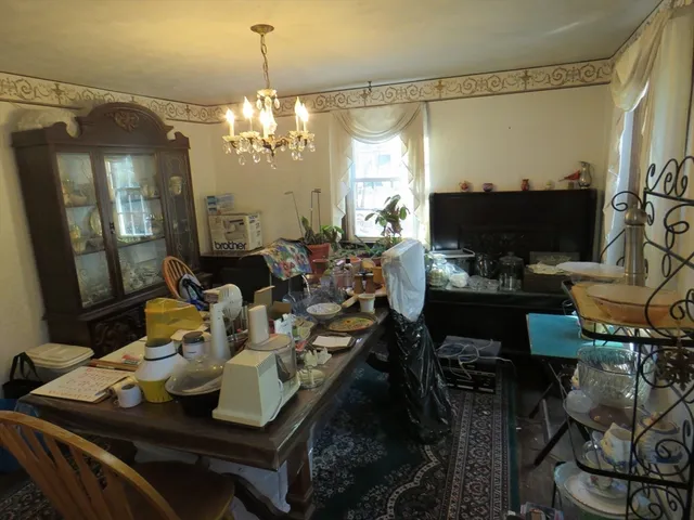 a dining room with furniture a chandelier and window