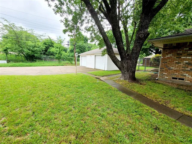 a view of a backyard with large trees
