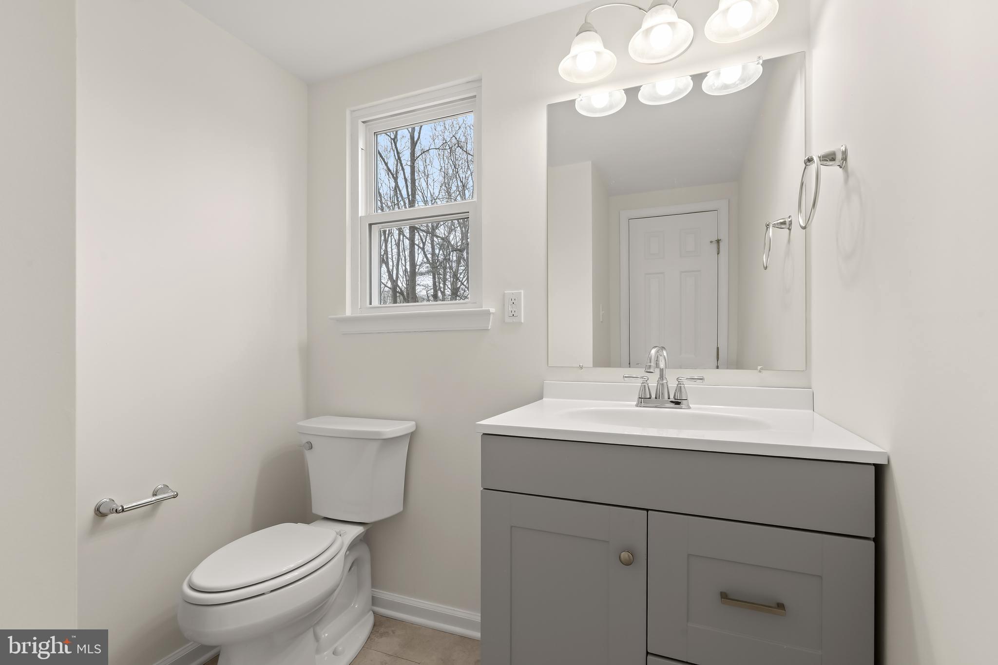 1255 Sheridan Road Crownsville, MD 21032 - Photo 19 of 40 a bathroom with a toilet a sink and mirror