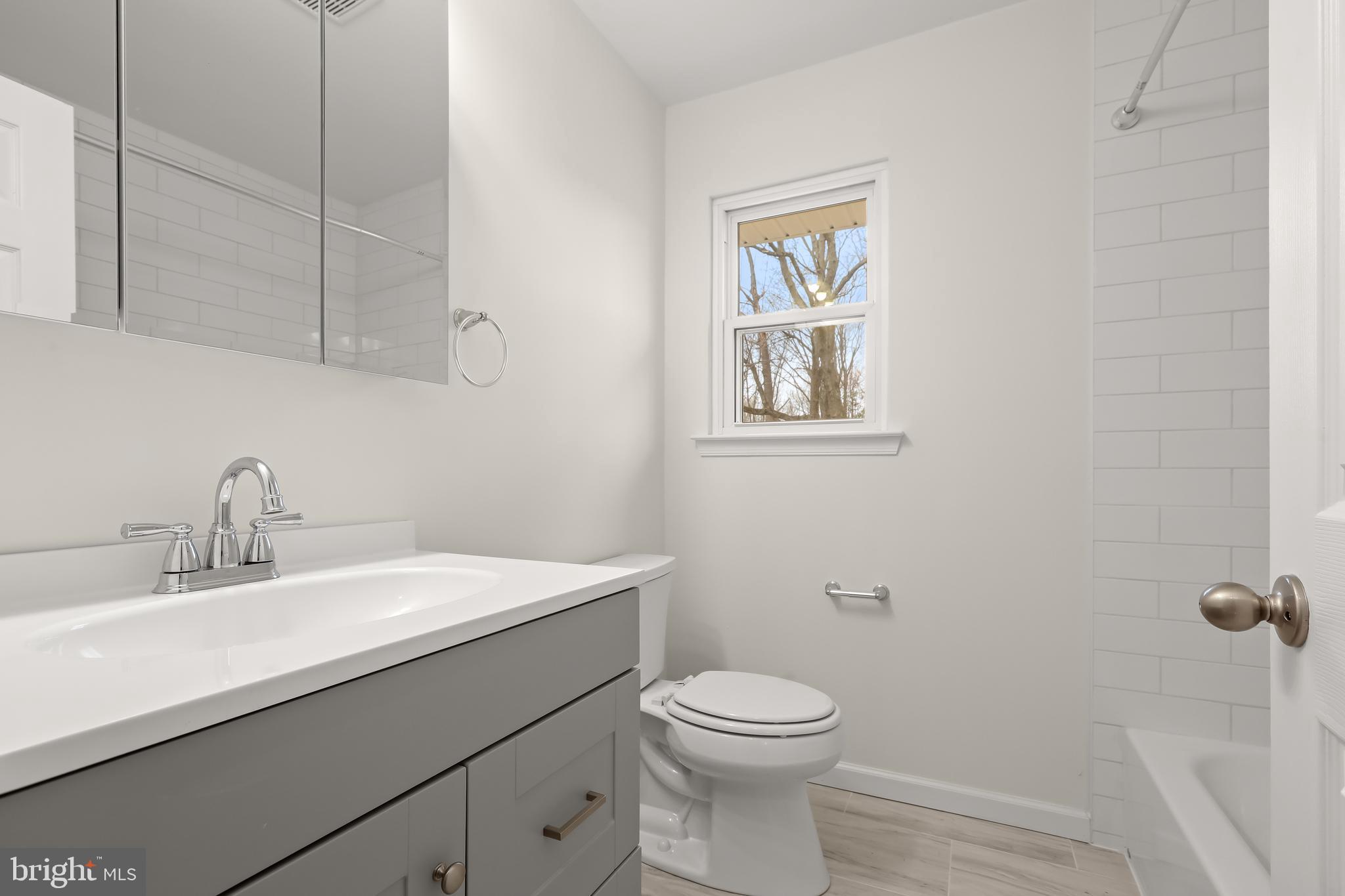 1255 Sheridan Road Crownsville, MD 21032 - Photo 31 of 40 a bathroom with a toilet a sink and mirror