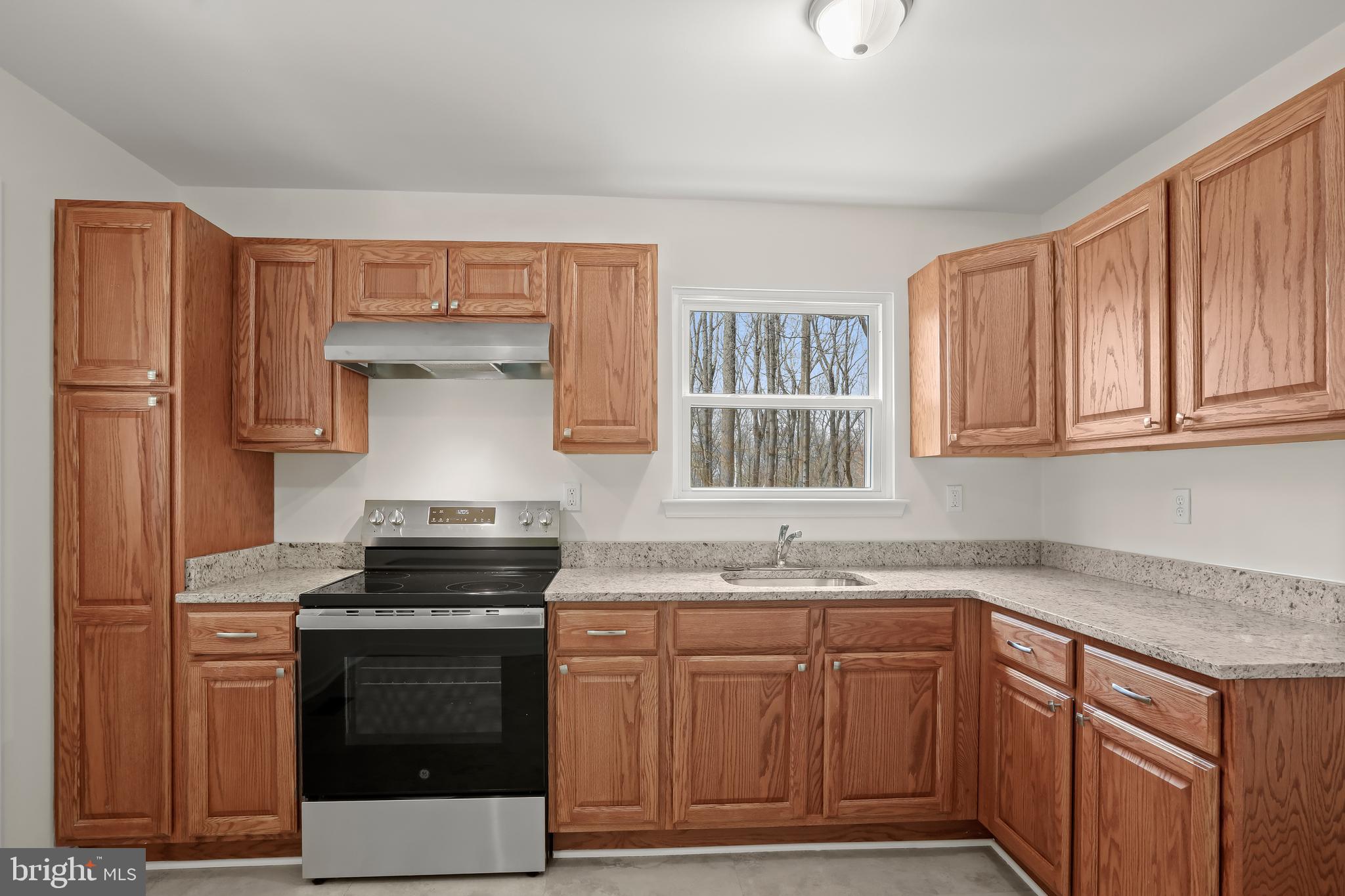 1255 Sheridan Road Crownsville, MD 21032 - Photo 8 of 40 a kitchen with granite countertop a sink stove and cabinets