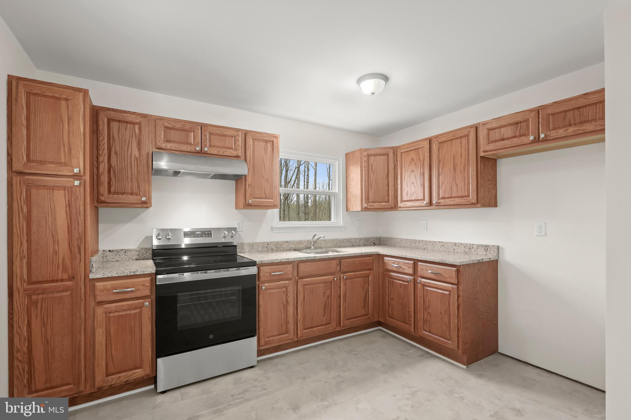 1255 Sheridan Road Crownsville, MD 21032 - Photo 9 of 40 a kitchen with stainless steel appliances a sink stove and cabinets