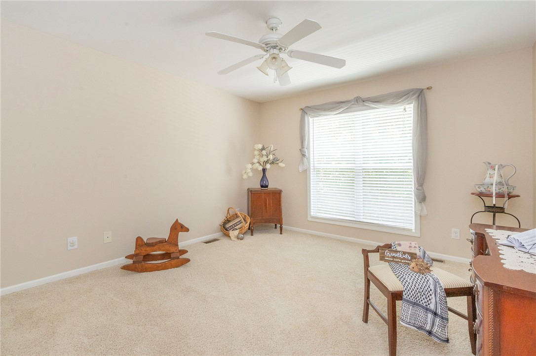125 Inlet Pointe Drive Anderson, SC 29625 - Photo 18 of 39 An inviting secondary bedroom offers soft carpeting and a ceiling fan for year-round comfort.