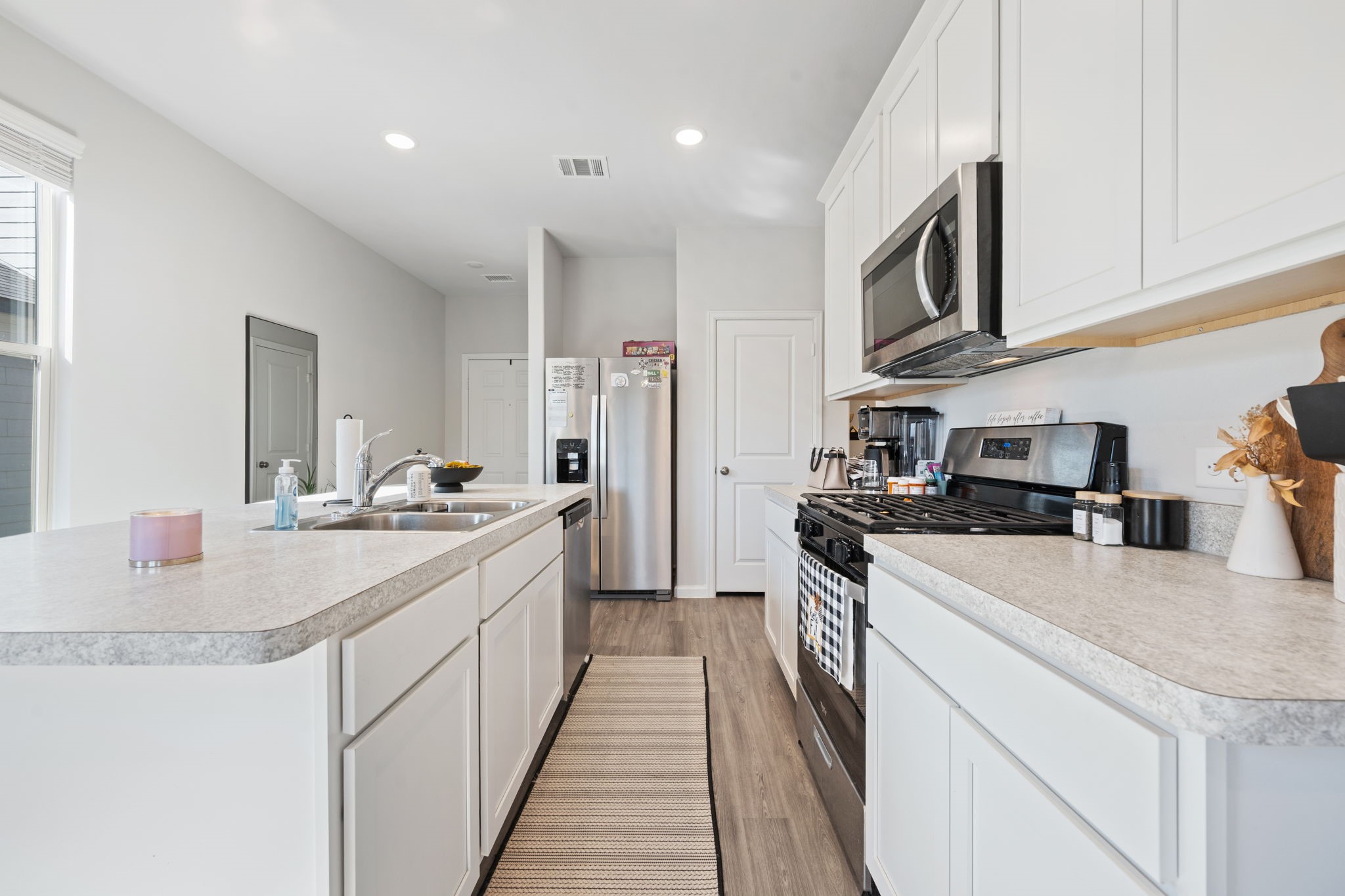 20819 Adventure Way Porter, TX 77365 - Photo 7 of 22 a kitchen with stainless steel appliances granite countertop a sink and dishwasher a stove top oven with wooden floor