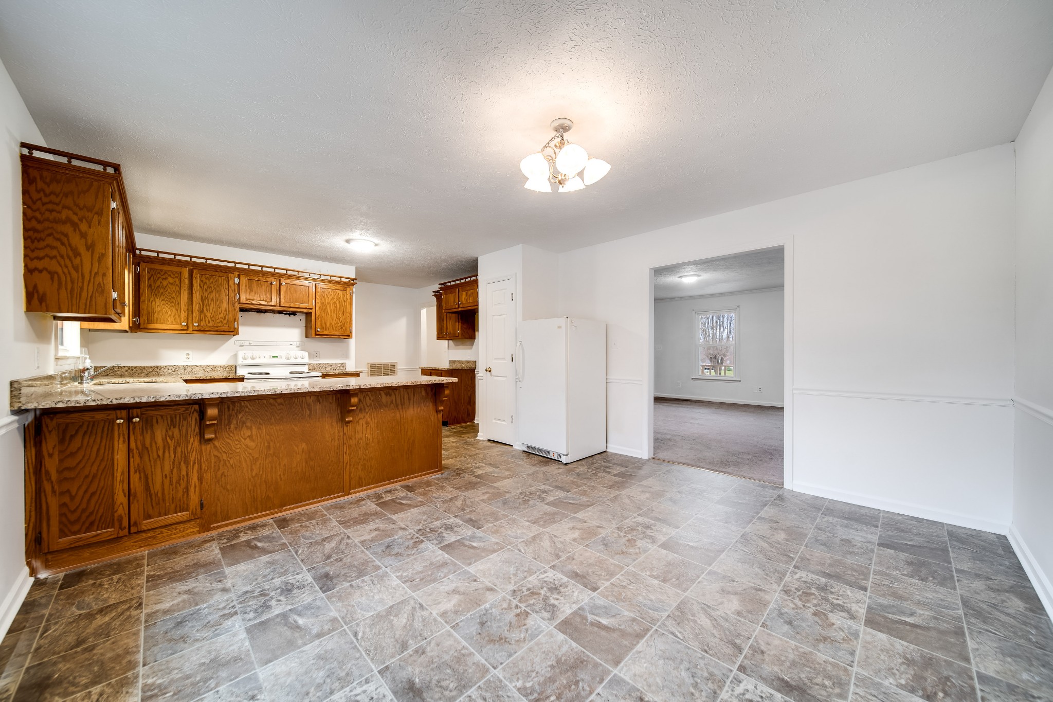 548 Goshen Road Lebanon, TN 37087 - Photo 8 of 23 a view of kitchen with granite countertop cabinets and refrigerator