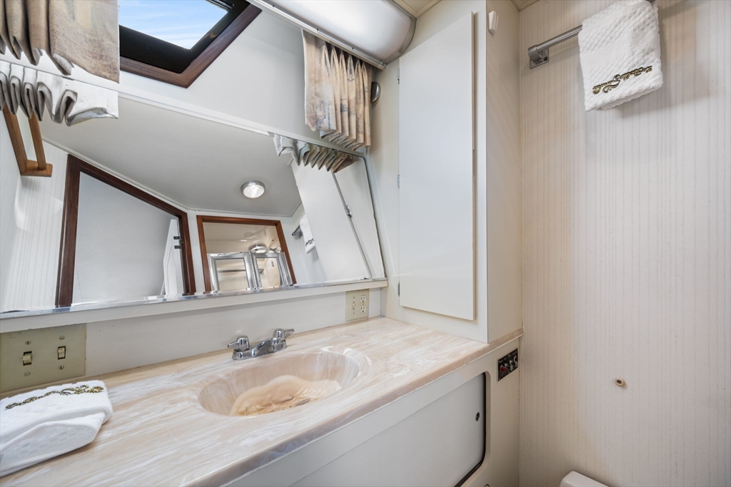 550 Pleasant Street, Unit 11D Winthrop, MA 02152 - Photo 17 of 30 a bathroom with a granite countertop sink and a mirror