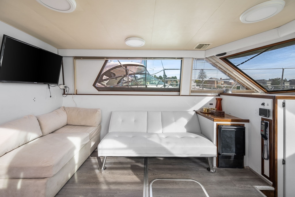 550 Pleasant Street, Unit 11D Winthrop, MA 02152 - Photo 4 of 30 a living room with furniture and a flat screen tv