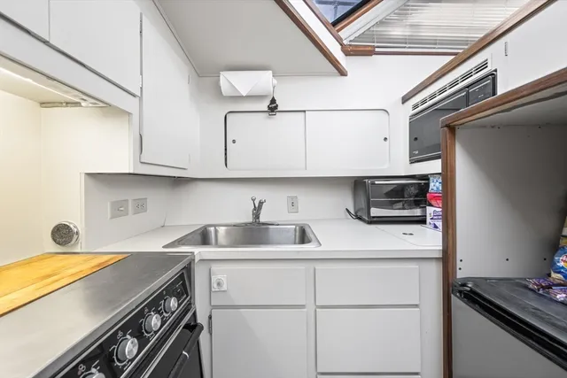 a kitchen with stainless steel appliances granite countertop a sink and a stove
