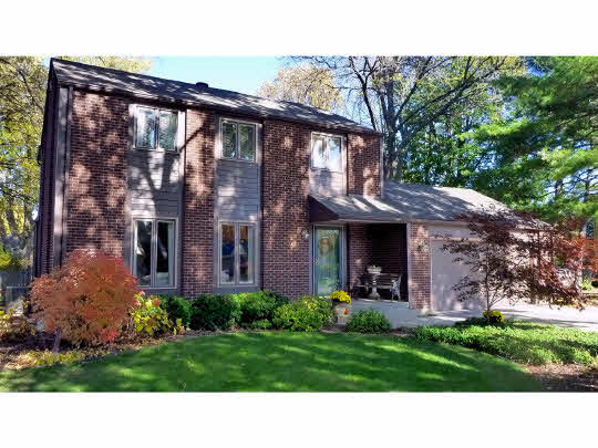 5004 Braewild Road Rockford, IL 61107 - Photo 1 of 11 a black and white house with a yard and garden