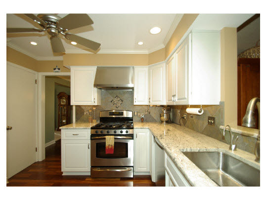 5004 Braewild Road Rockford, IL 61107 - Photo 2 of 11 a kitchen with stainless steel appliances granite countertop a sink a stove and a refrigerator