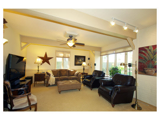 5004 Braewild Road Rockford, IL 61107 - Photo 4 of 11 a living room with furniture a flat screen tv and a fireplace