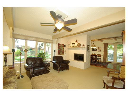 5004 Braewild Road Rockford, IL 61107 - Photo 7 of 11 a living room with furniture a fireplace and a large window