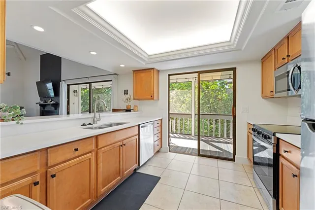 a living room with furniture and large windows