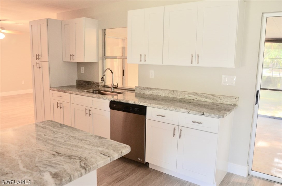 14120 River Road Fort Myers, FL 33905 - Photo 12 of 35 a kitchen with stainless steel appliances granite countertop a sink stove and white cabinets