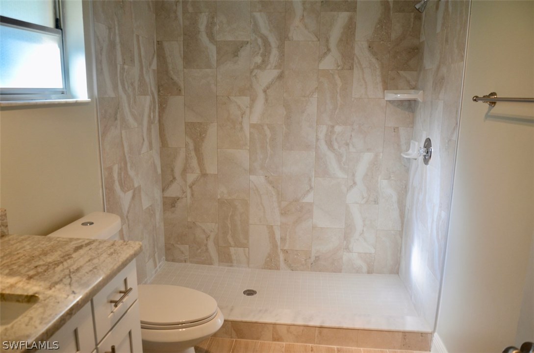 14120 River Road Fort Myers, FL 33905 - Photo 18 of 35 a bathroom with a granite countertop bathtub shower sink vanity and toilet