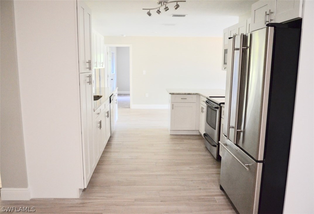 14120 River Road Fort Myers, FL 33905 - Photo 7 of 35 a view of a kitchen with a refrigerator and a sink
