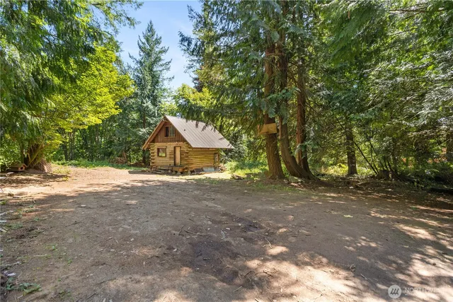 a wooden house with trees in front of it