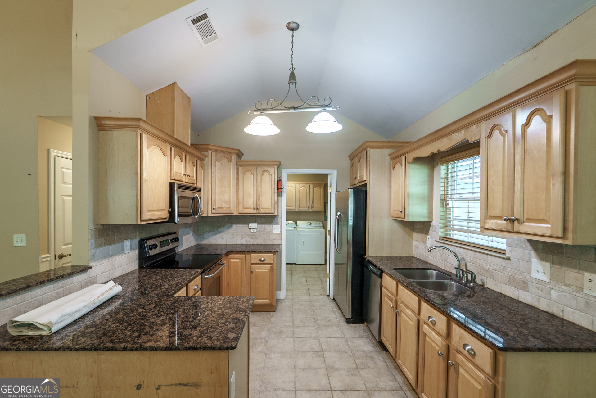 1491 Swords Trail Buckhead, GA 30625 - Photo 17 of 52 a large kitchen with kitchen island granite countertop a sink and a stove top oven with granite countertops