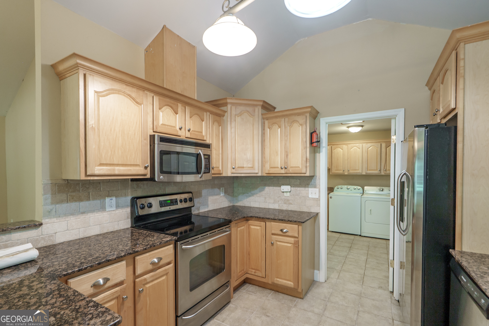 1491 Swords Trail Buckhead, GA 30625 - Photo 18 of 52 a kitchen with stainless steel appliances granite countertop a stove a sink and a refrigerator