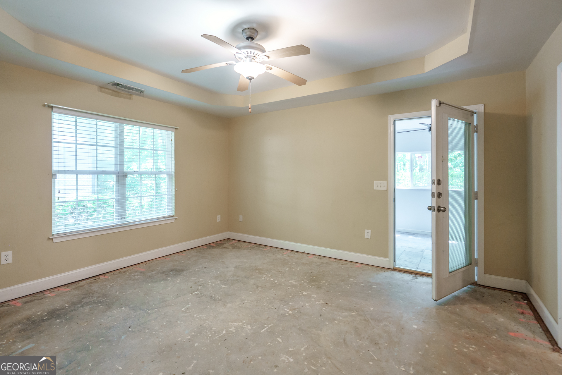 1491 Swords Trail Buckhead, GA 30625 - Photo 27 of 52 an empty room with windows and chandelier fan