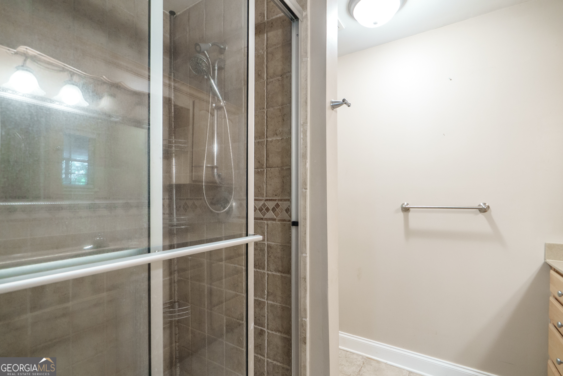1491 Swords Trail Buckhead, GA 30625 - Photo 31 of 52 a bathroom with a glass shower door