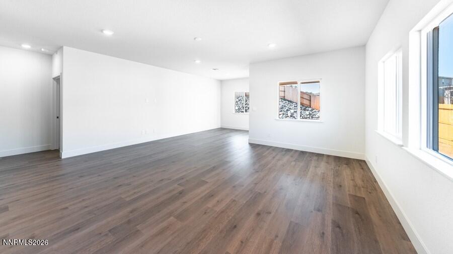500 Daisy Fay Way Carson City, NV 89705 - Photo 9 of 22 a view of an empty room with wooden floor and a window