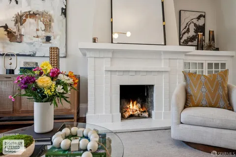 a living room with furniture and flowers