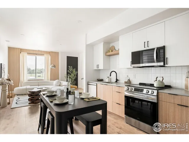 a kitchen with stainless steel appliances granite countertop a sink a stove and microwave