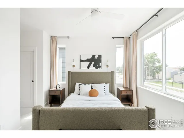a bedroom with furniture and a potted plant