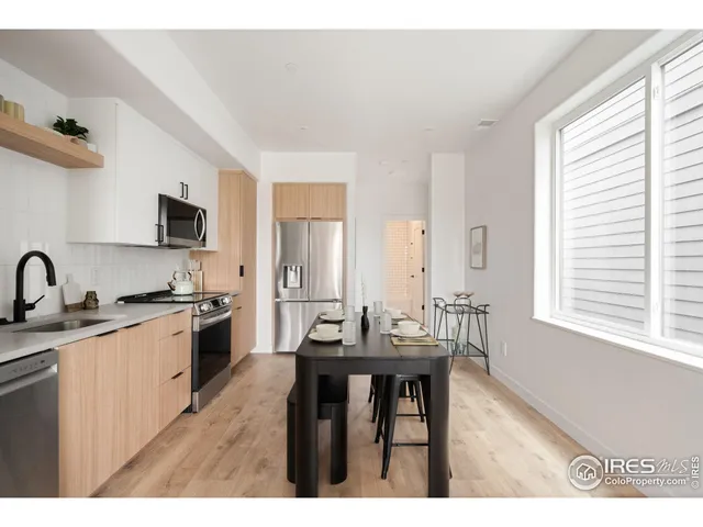 a kitchen with stainless steel appliances kitchen island granite countertop a sink stove and microwave