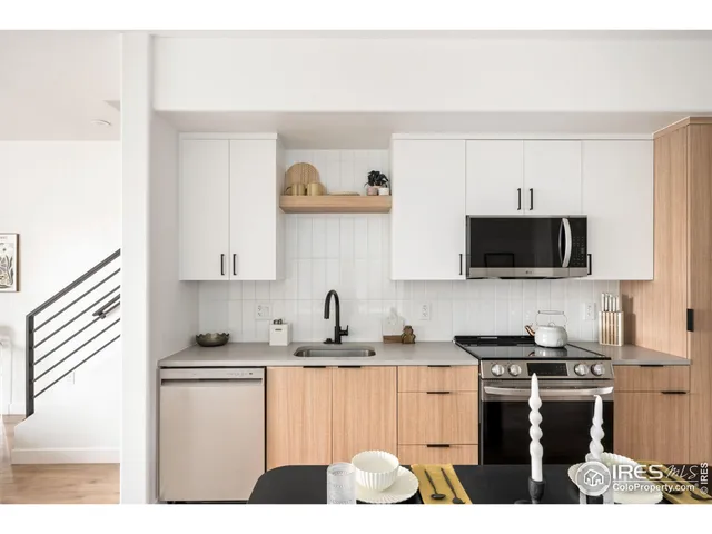 a kitchen with a sink cabinets and wooden floor