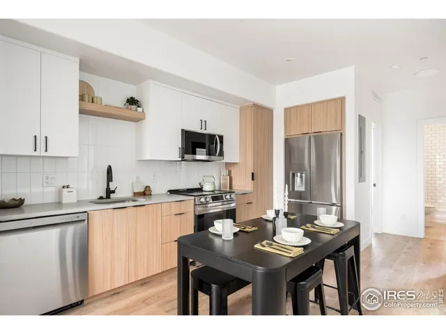 a view of a dining room with furniture and a flat screen tv
