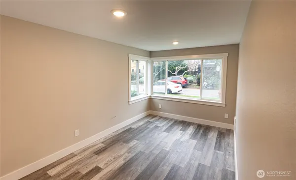 a view of kitchen with sink and refrigerator