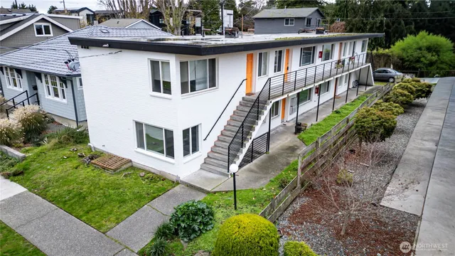 a aerial view of a house with a yard and potted plants