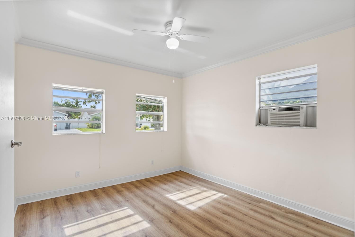 8991 Southwest 7th Street Boca Raton, FL 33433 - Photo 33 of 69 a view of an empty room with wooden floor and a window