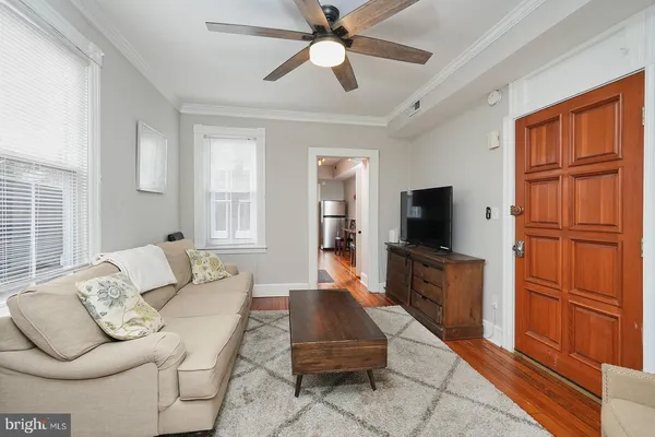a view of a dining room with furniture a rug and wooden floor