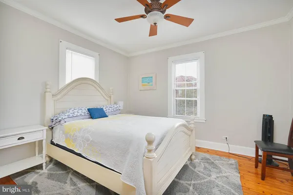 a living room with furniture a ceiling fan and a window